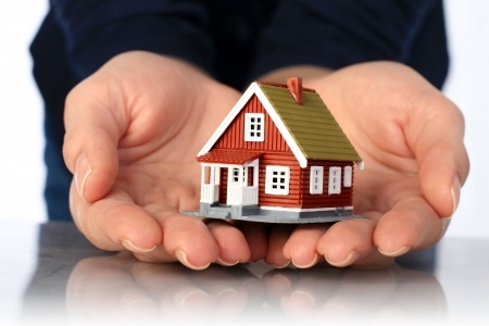 7023687 - hands and small house. real estate or insurance concept.